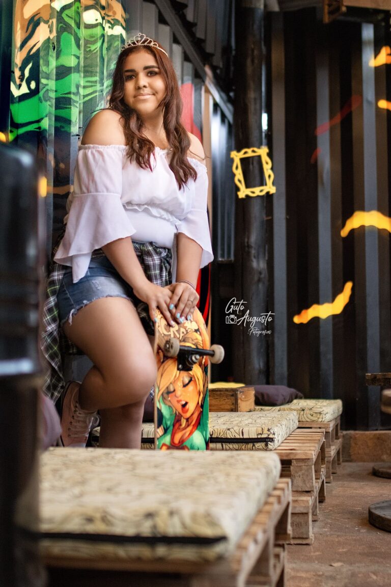 Alana posando com um skate durante seu ensaio de 15 anos em Guaíba, mostrando um estilo jovem e autêntico.